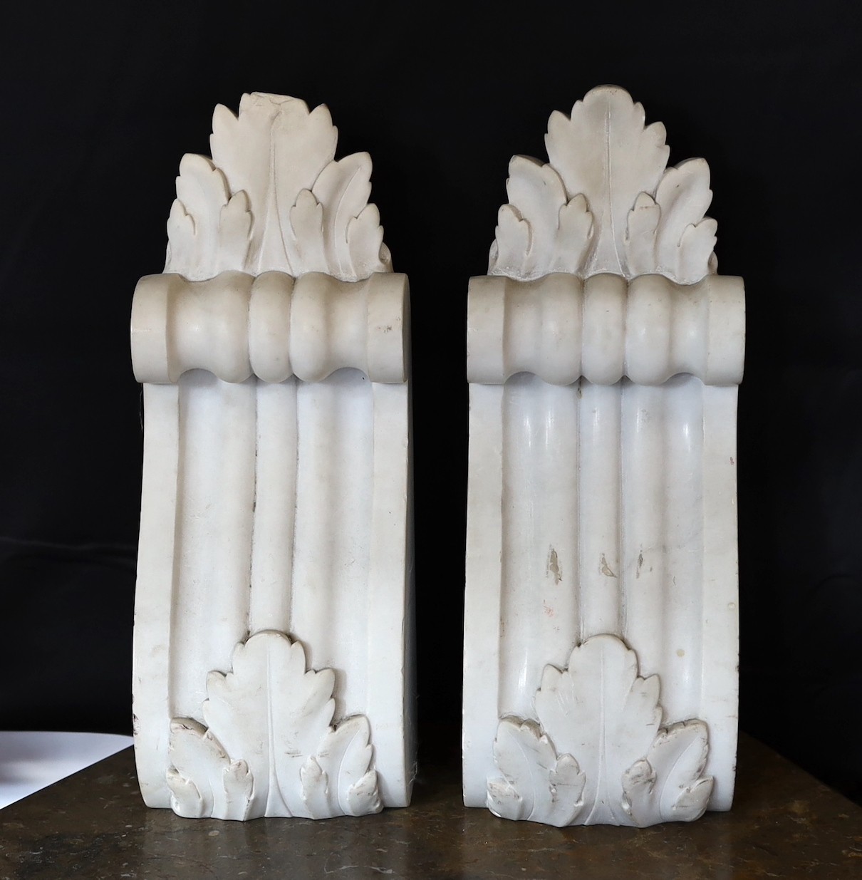 A pair of Victorian cast iron corbels and a pair of carved white marble corbels, height 26cm & 35cm